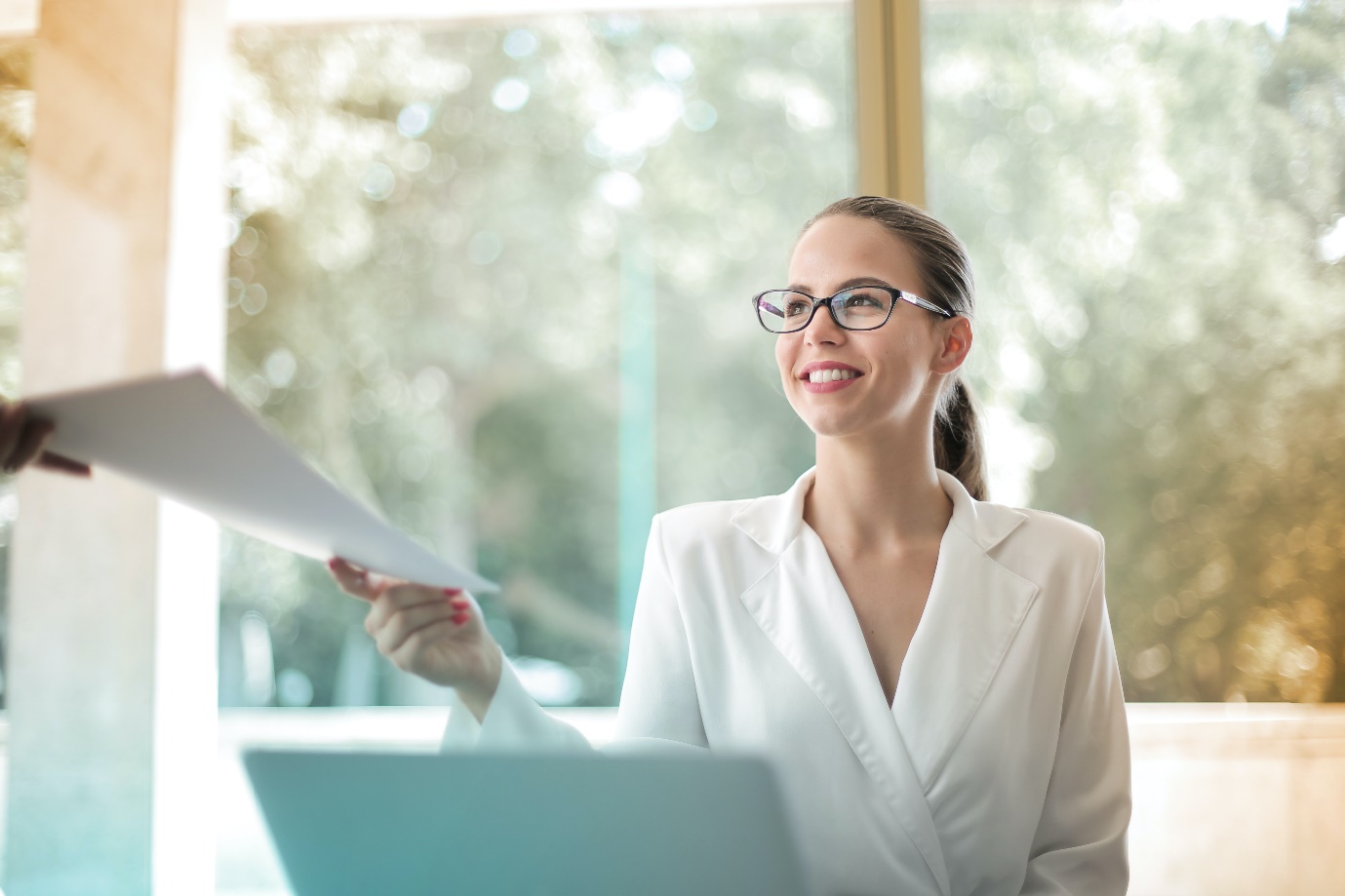 Woman being handed office documents